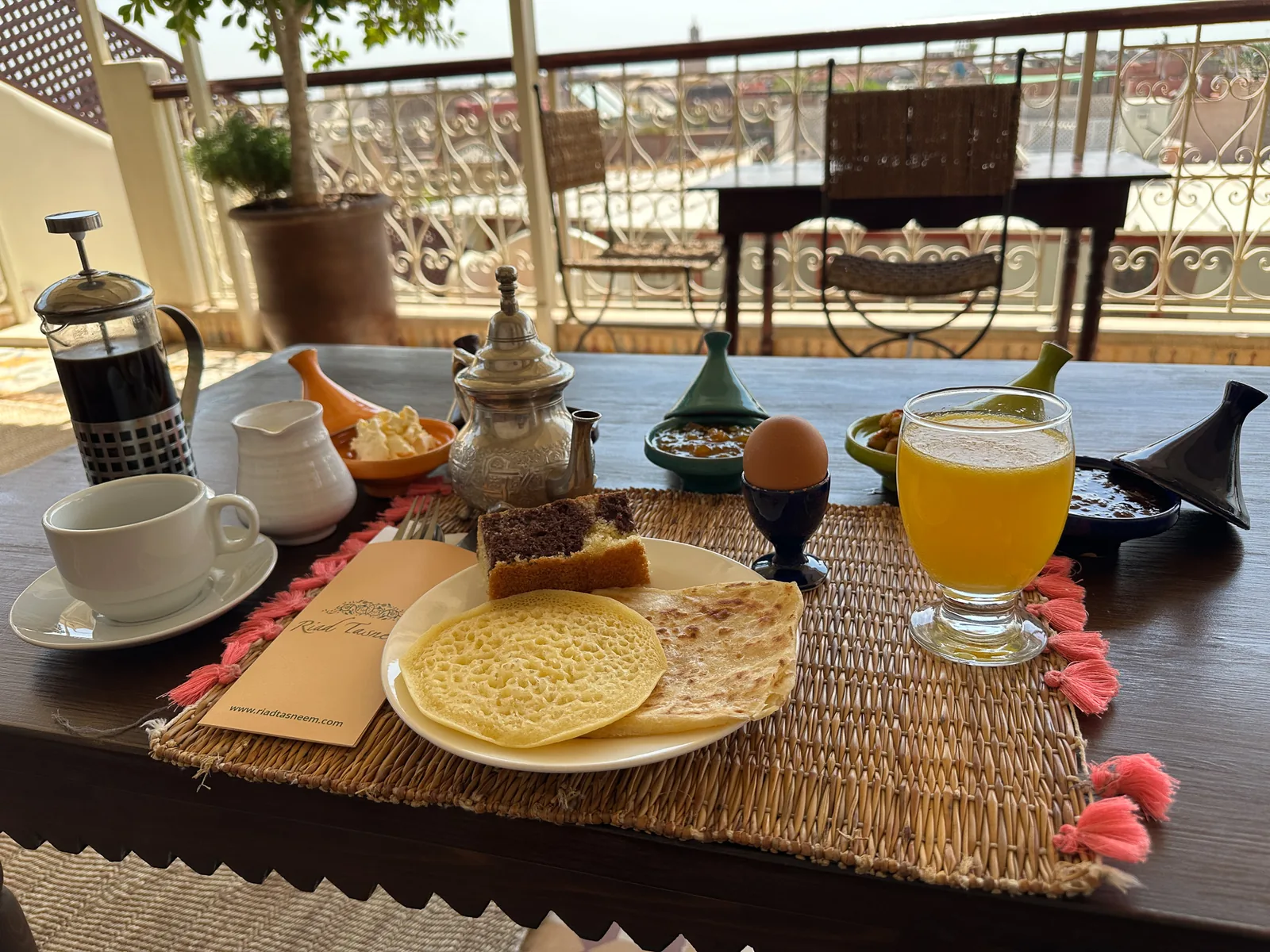 Breakfast on the rooftop terrace of Riad Tasneem with the rooftops of the medina behind