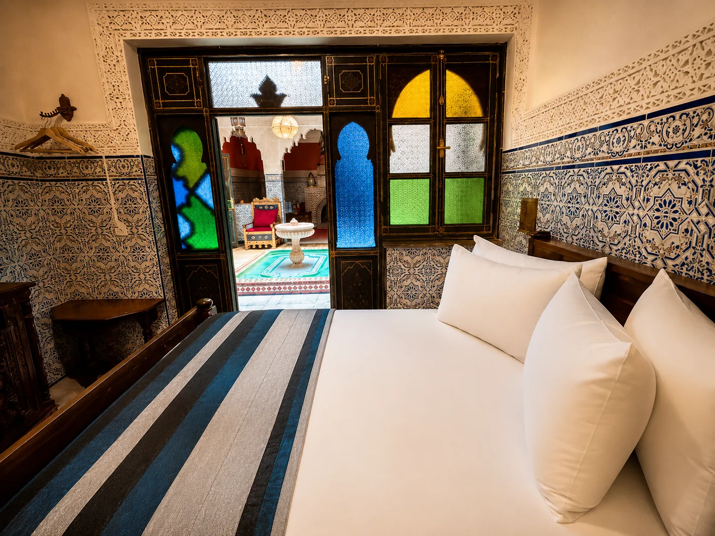 Laila: double room at Riad Tasneem with view from the bed through the stained-glass door onto the patio with the central fountain, on the ground floor